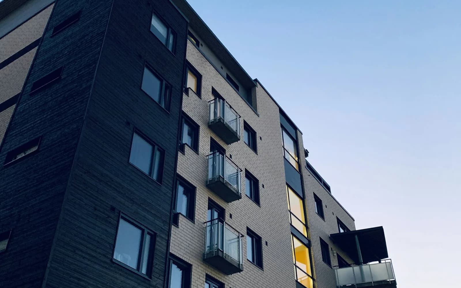 Modern multi-unit residential block at dusk